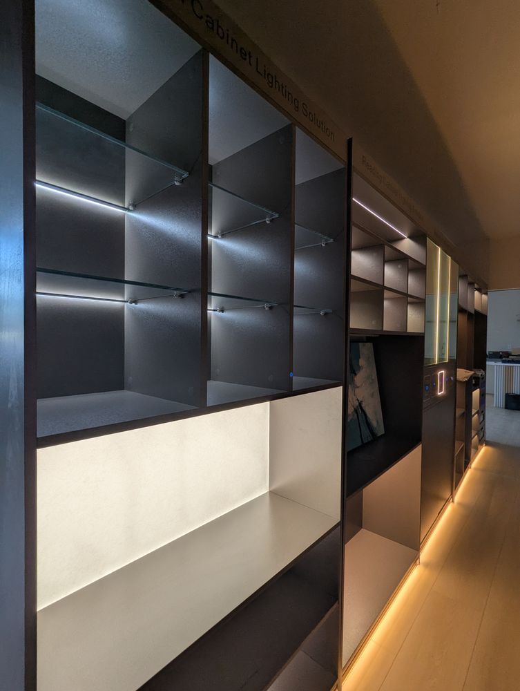 Armonia showroom — dark cabinet display with ambient lighting